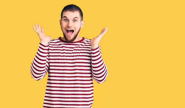 Young Handsome Man Wearing Striped Sweater Celebrating Crazy Amazed Success — Stock Photo, Image
