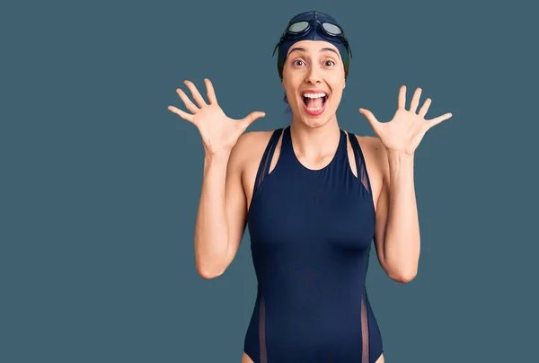 Young Beautiful Hispanic Woman Wearing Swimwear Swimmer Glasses Celebrating Crazy — Stock Photo, Image