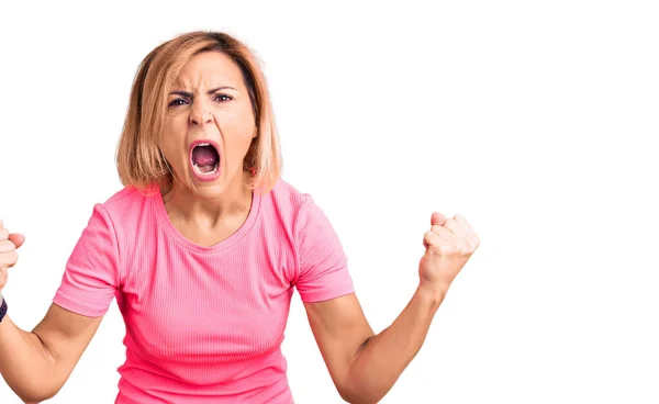 Young Blonde Woman Wearing Sportswear Angry Mad Raising Fists Frustrated — Stock Photo, Image