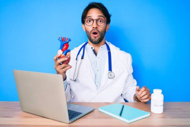 Yakışıklı, doktor üniforması giyen, kalbi tutan, ağzı açık, korkmuş, şaşırmış, imansız bir adam. 