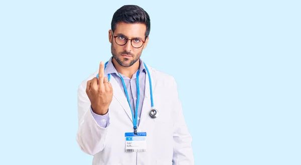 Young Hispanic Man Wearing Doctor Uniform Stethoscope Showing Middle Finger —  Fotos de Stock