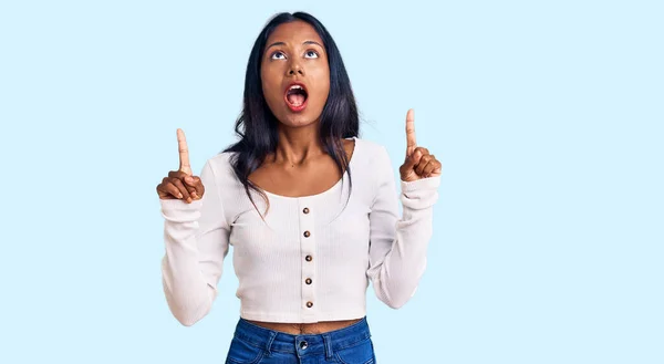 Young Indian Girl Wearing Casual Clothes Amazed Surprised Looking Pointing — Stock Photo, Image