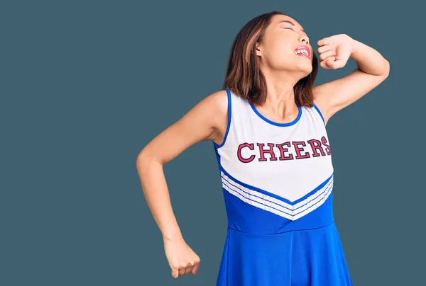 Young Beautiful Chinese Girl Wearing Cheerleader Uniform Stretching Back Tired — Stock Photo, Image