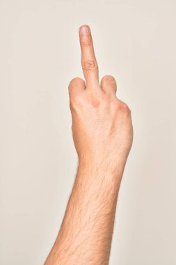 Hand of caucasian young man showing fingers over isolated white background showing provocative and rude gesture doing fuck you symbol with middle finger