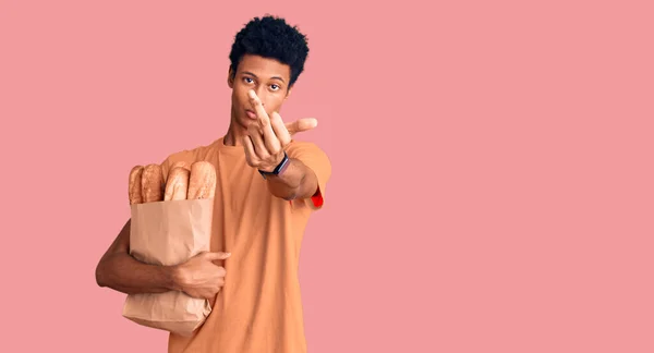Young African American Man Holding Paper Bag Bread Showing Middle — Foto Stock