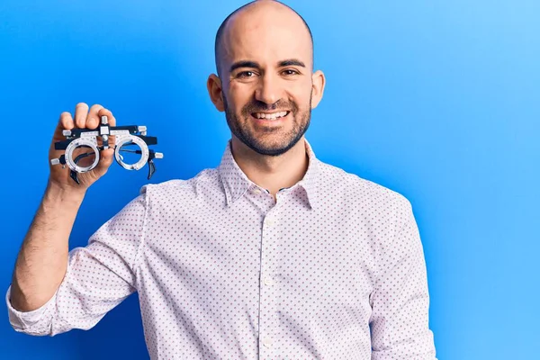 Young Handsome Bald Man Holding Optometry Glasses Looking Positive Happy — Stock Photo, Image