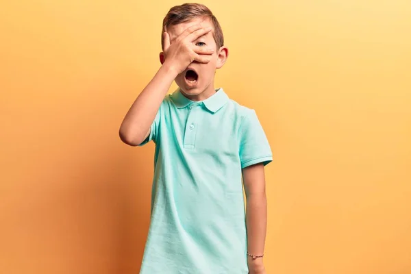 Cute Blond Kid Wearing Casual Clothes Peeking Shock Covering Face — Stock Photo, Image