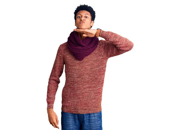 若いアフリカ系アメリカ人の男はナイフで手で喉を切るカジュアルな冬のセーターとスカーフを着て 激しい暴力で侵略を脅かす — ストック写真