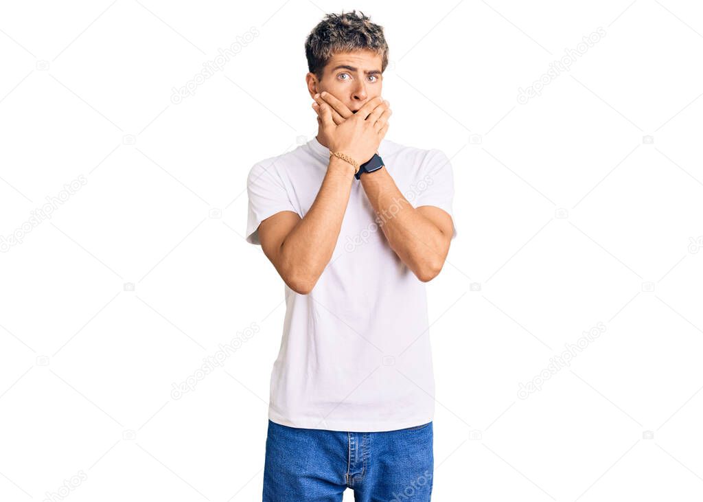 Young handsome man wearing casual white tshirt shocked covering mouth with hands for mistake. secret concept. 