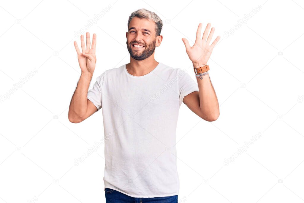 Young handsome blond man wearing casual t-shirt showing and pointing up with fingers number nine while smiling confident and happy. 
