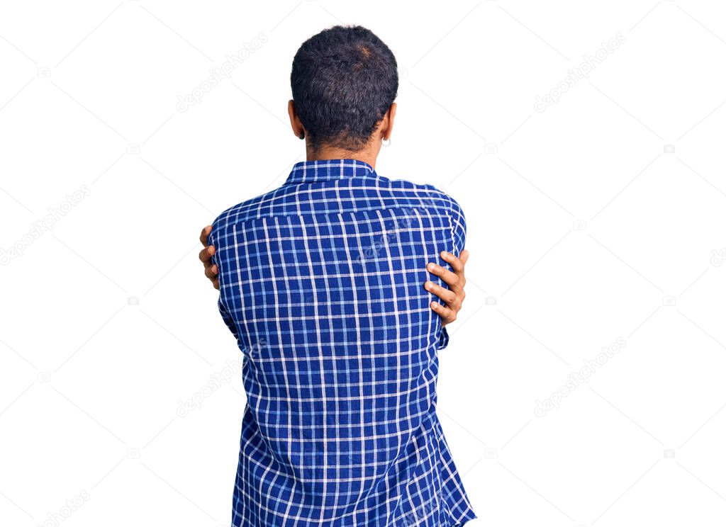 Young african amercian man wearing casual clothes standing backwards looking away with crossed arms 