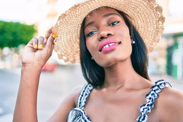 Young african american woman on vacation smiling happy walking at street of city