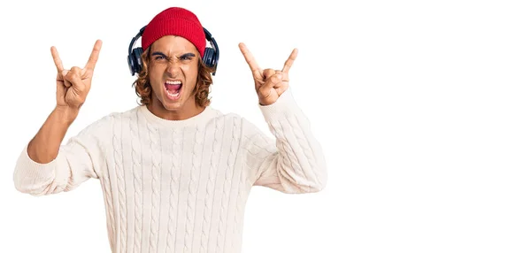 Young Hispanic Man Listening Music Using Headphones Shouting Crazy Expression — Stock Photo, Image