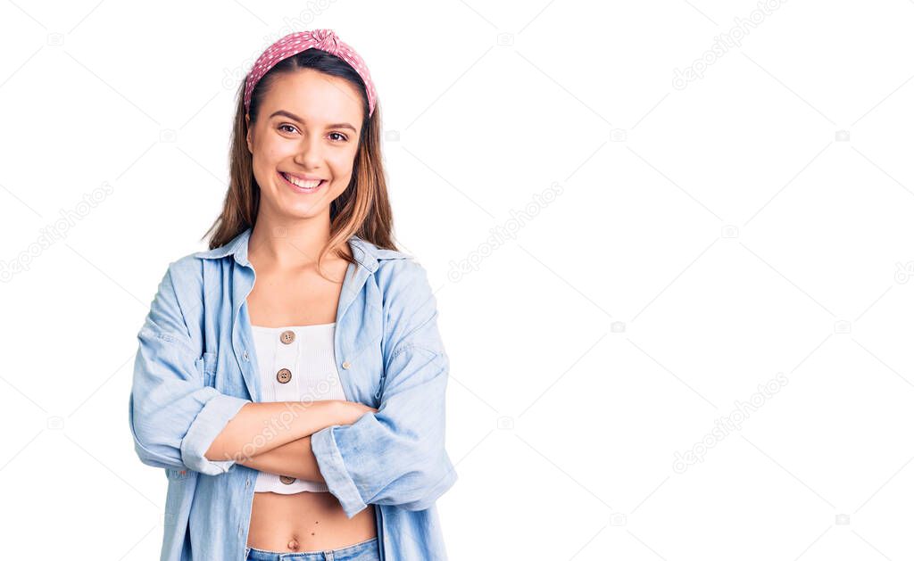 Young beautiful girl wearing casual shirt and diadem happy face smiling with crossed arms looking at the camera. positive person. 