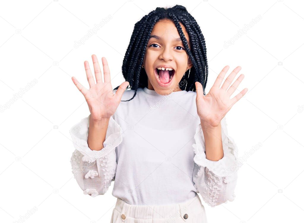 Cute african american girl wearing casual white tshirt showing and pointing up with fingers number ten while smiling confident and happy. 
