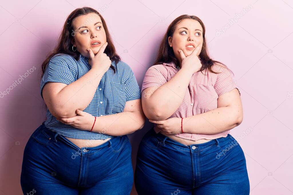 Young plus size twins wearing casual clothes thinking worried about a question, concerned and nervous with hand on chin 
