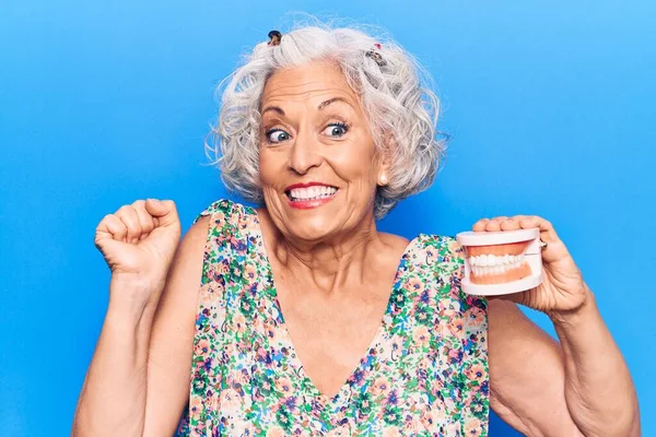 Senior Grey Haired Woman Holding Denture Screaming Proud Celebrating Victory — Stock Photo, Image