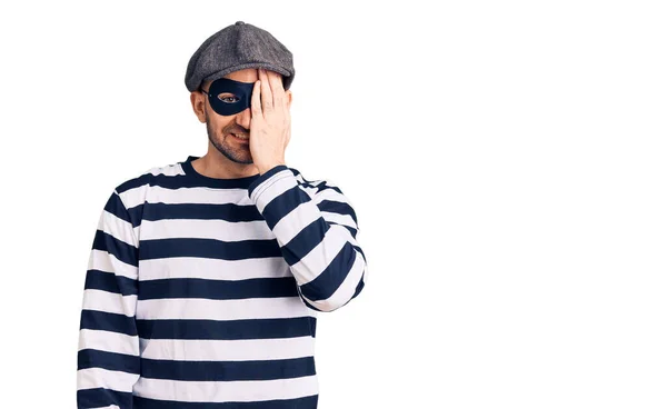Young Handsome Man Wearing Burglar Mask Covering One Eye Hand — Stock Photo, Image
