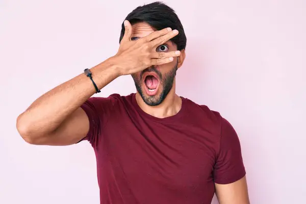 Handsome Hispanic Man Wearing Casual Clothes Peeking Shock Covering Face — Stock Photo, Image