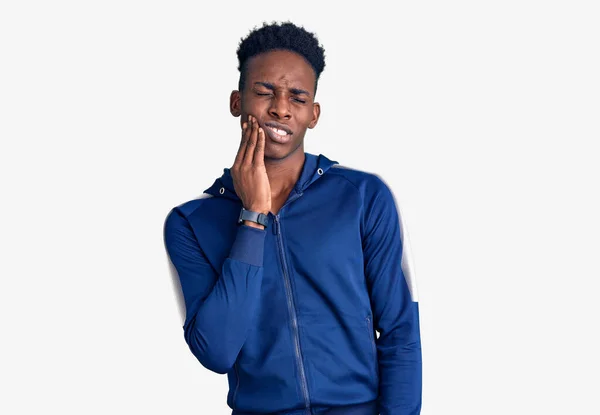 歯の痛みや歯の病気のために痛みを伴う表現で手に触れるスポーツウェアを身に着けている若いアフリカ系アメリカ人男性 歯科医 — ストック写真