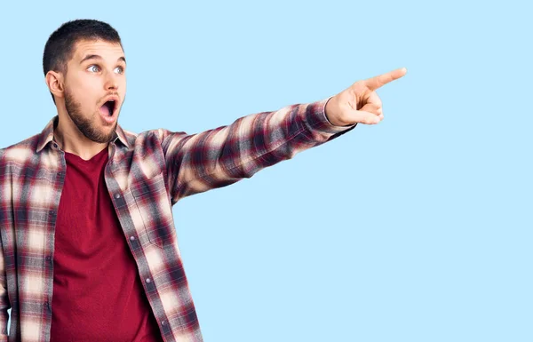 Young Handsome Man Wearing Casual Shirt Pointing Finger Surprised Ahead — Stock Photo, Image