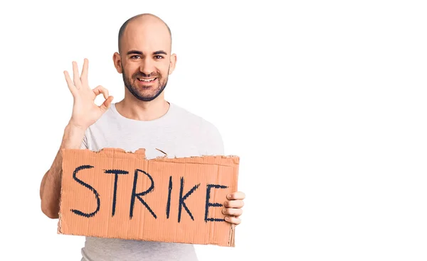Young Handsome Man Holding Strike Banner Doing Sign Fingers Smiling — Stock Photo, Image