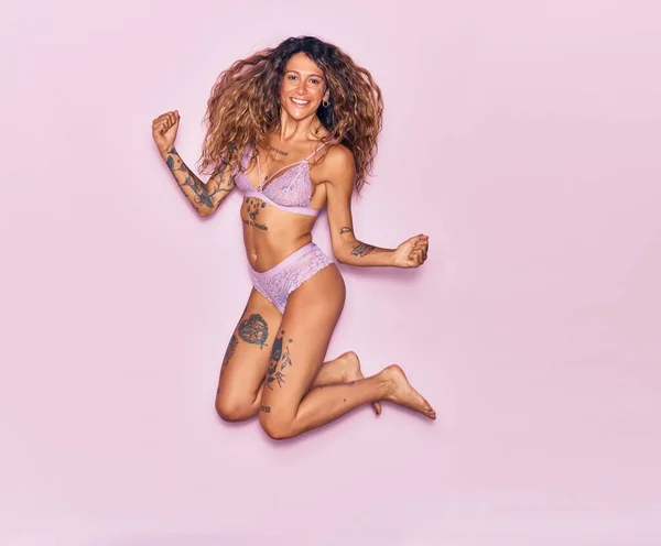 Young Beautiful Woman Tattoo Wearing Lingerie Smiling Happy Jumping Smile — Stock Photo, Image