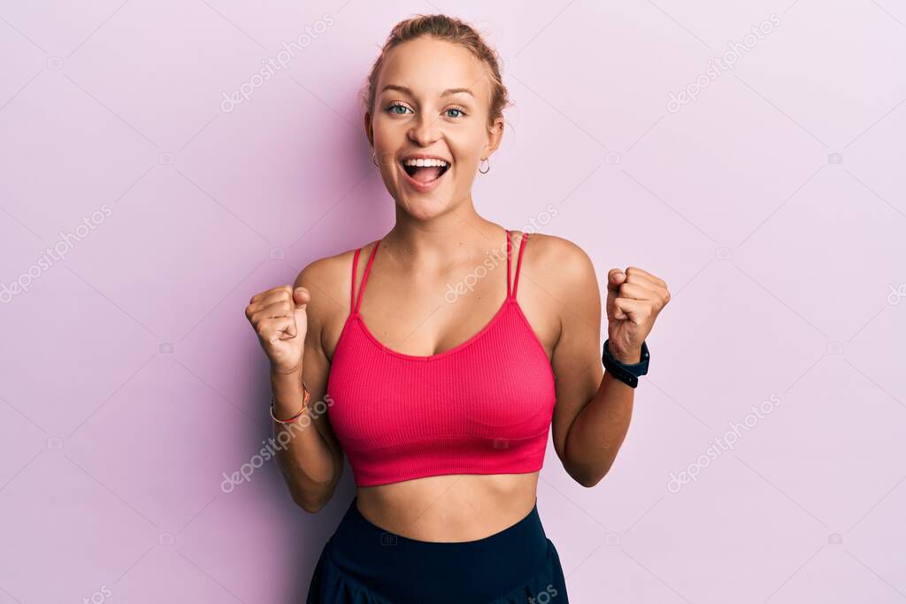 Beautiful caucasian woman wearing sportswear celebrating surprised and amazed for success with arms raised and open eyes. winner concept. 