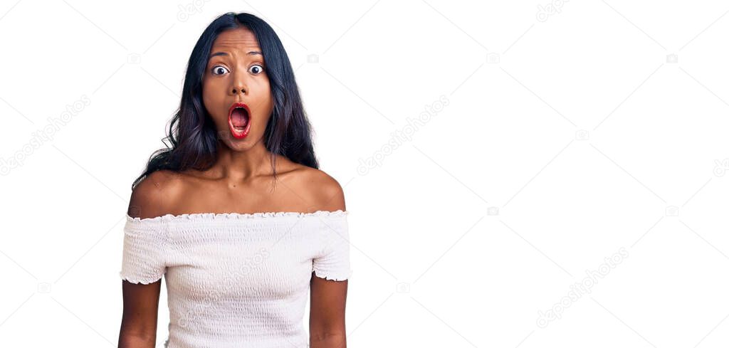 Young indian girl wearing casual clothes scared and amazed with open mouth for surprise, disbelief face 