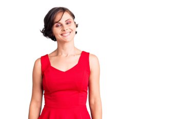 Kısa saçlı, gündelik tarzda giyinen, kolsuz gömlekli, yüzünde mutlu ve havalı bir gülümseme olan güzel bir kadın. şanslı kişi. 