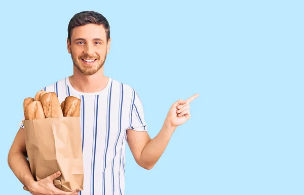 Handsome Young Man Bear Holding Paper Bag Bread Smiling Happy — Stock Photo, Image