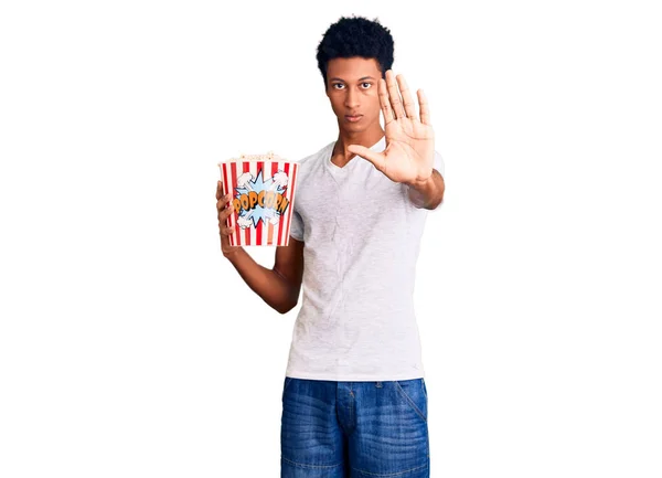 Young African American Man Holding Popcorn Open Hand Doing Stop — Stock Photo, Image