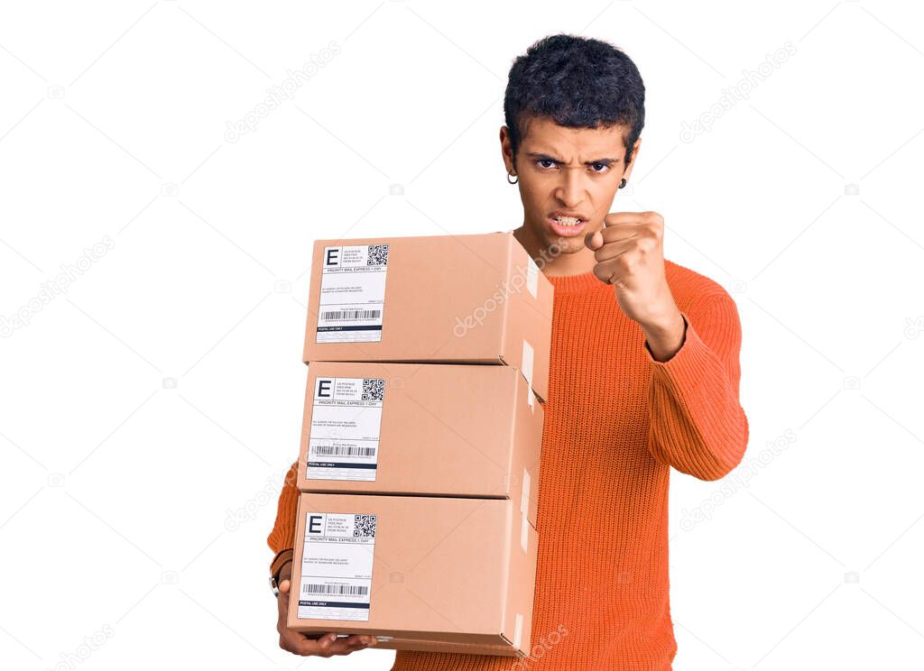 Young african amercian man holding delivery package annoyed and frustrated shouting with anger, yelling crazy with anger and hand raised 