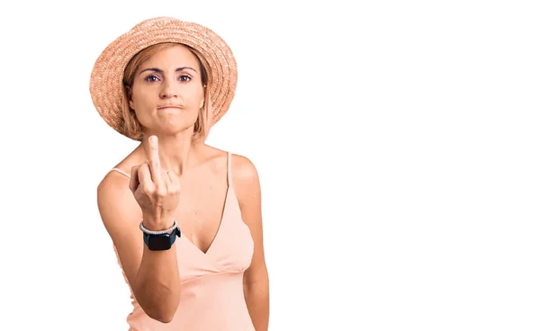 Young Blonde Woman Wearing Summer Hat Showing Middle Finger Impolite — стоковое фото