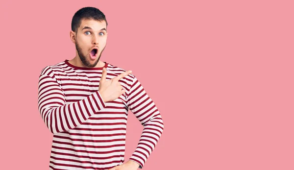 Young Handsome Man Wearing Striped Sweater Surprised Pointing Finger Side — Stock Photo, Image
