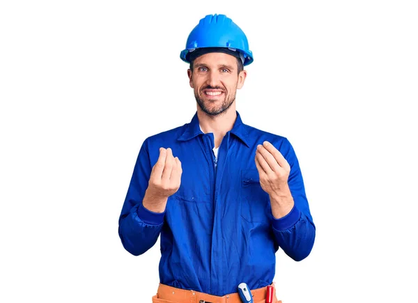 Jovem Homem Bonito Vestindo Uniforme Trabalhador Hardhat Fazendo Gesto Dinheiro — Fotografia de Stock