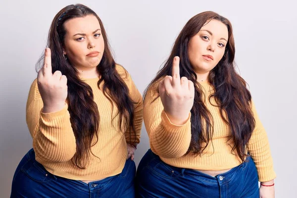 Young Size Twins Wearing Casual Clothes Showing Middle Finger Impolite — стоковое фото