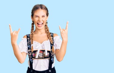 Sarışın, beyaz bir kadın. Geleneksel kıyafetler giyiyor. Çılgın bir ifadeyle bağırıyor. Müzik yıldızı. ağır kavram. 