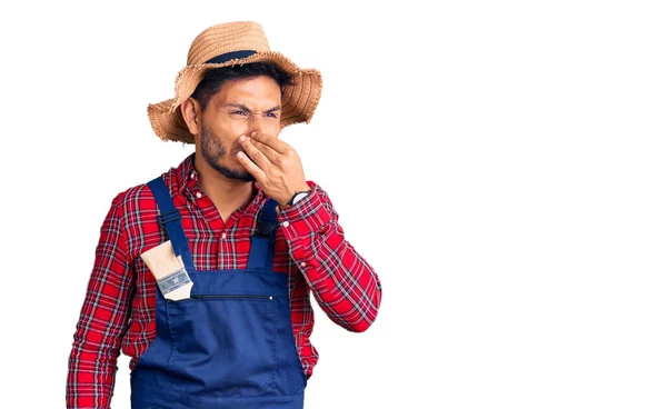 Handsome Latin American Young Man Weaing Handyman Uniform Smelling Something — Stock Photo, Image