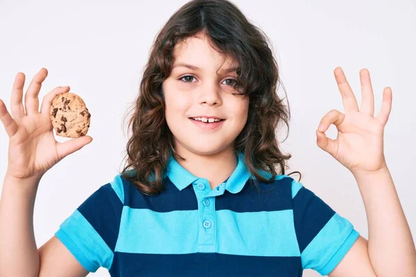 Cute Hispanic Child Long Hair Holding Cookie Doing Sign Fingers — Stock Photo, Image