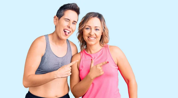 Couple Women Wearing Sportswear Cheerful Smile Face Pointing Hand Finger — Stock Photo, Image