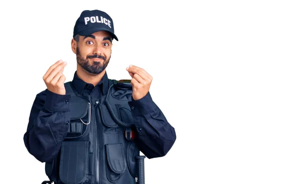 Jonge Spaanse Man Draagt Politie Uniform Doet Geld Gebaar Met — Stockfoto