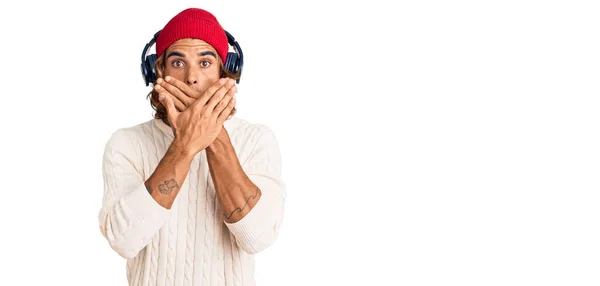 Young Hispanic Man Listening Music Using Headphones Shocked Covering Mouth — Stock Photo, Image