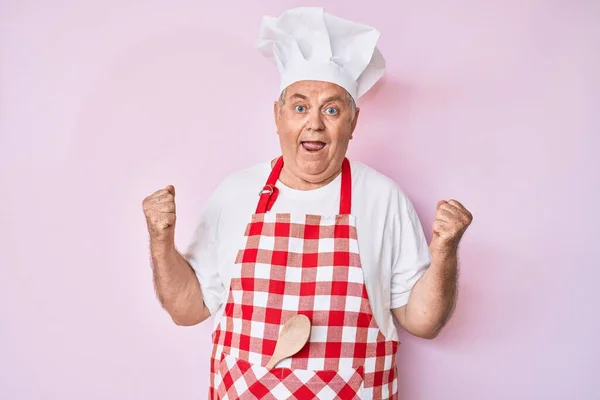 Senior Grey Haired Man Wearing Professional Baker Apron Celebrating Surprised — Stock Photo, Image