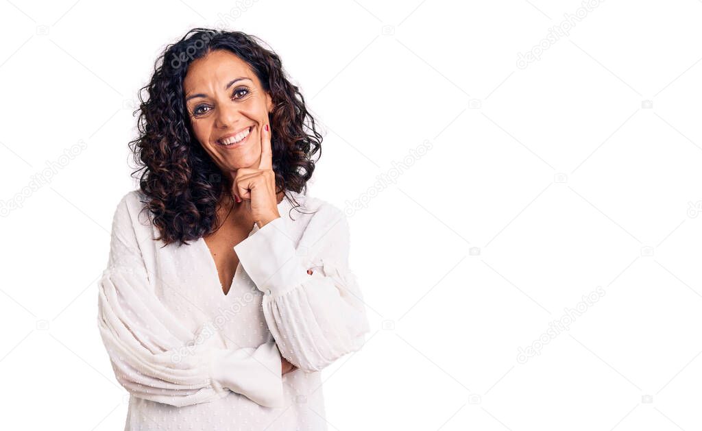 Middle age beautiful woman wearing casual sweater looking confident at the camera with smile with crossed arms and hand raised on chin. thinking positive. 
