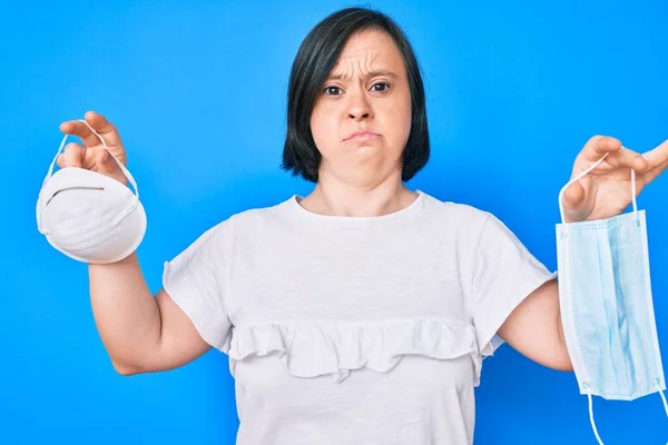 Brunette Woman Syndrome Holding Two Different Safety Masks Skeptic Nervous — Stock Photo, Image