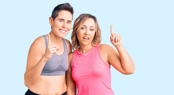 Couple Women Wearing Sportswear Pointing Finger Successful Idea Exited Happy — Stock Photo, Image