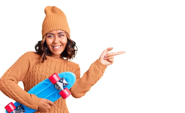 Junge Schöne Mischlingshündin Hält Schlittschuh Lächelnd Glücklich Und Zeigt Mit — Stockfoto