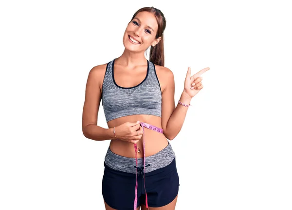 Young Beautiful Hispanic Woman Wearing Sportswear Using Tape Measure Smiling — Stock Photo, Image