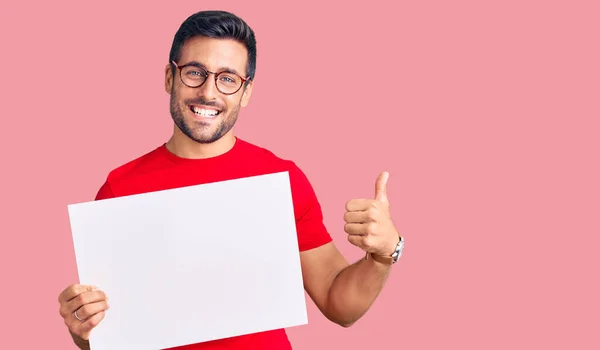 Young Hispanic Man Holding Blank Empty Banner Smiling Happy Positive — Stock Photo, Image